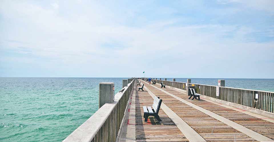 Pensacola Florida pier on a bright summer day looking out to the ocean