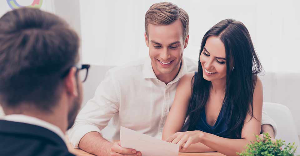 Real estate agent giving consultation to couple about buying house
