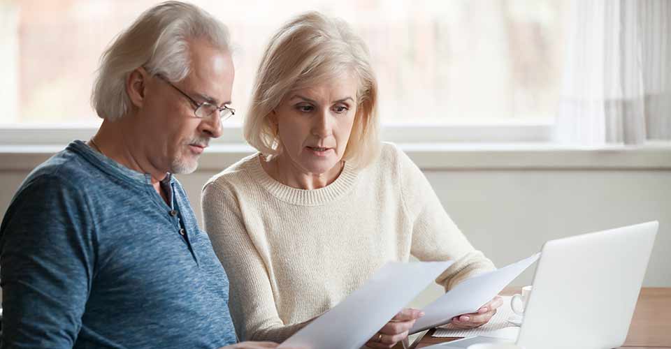 Senior couple reading mortgage documents